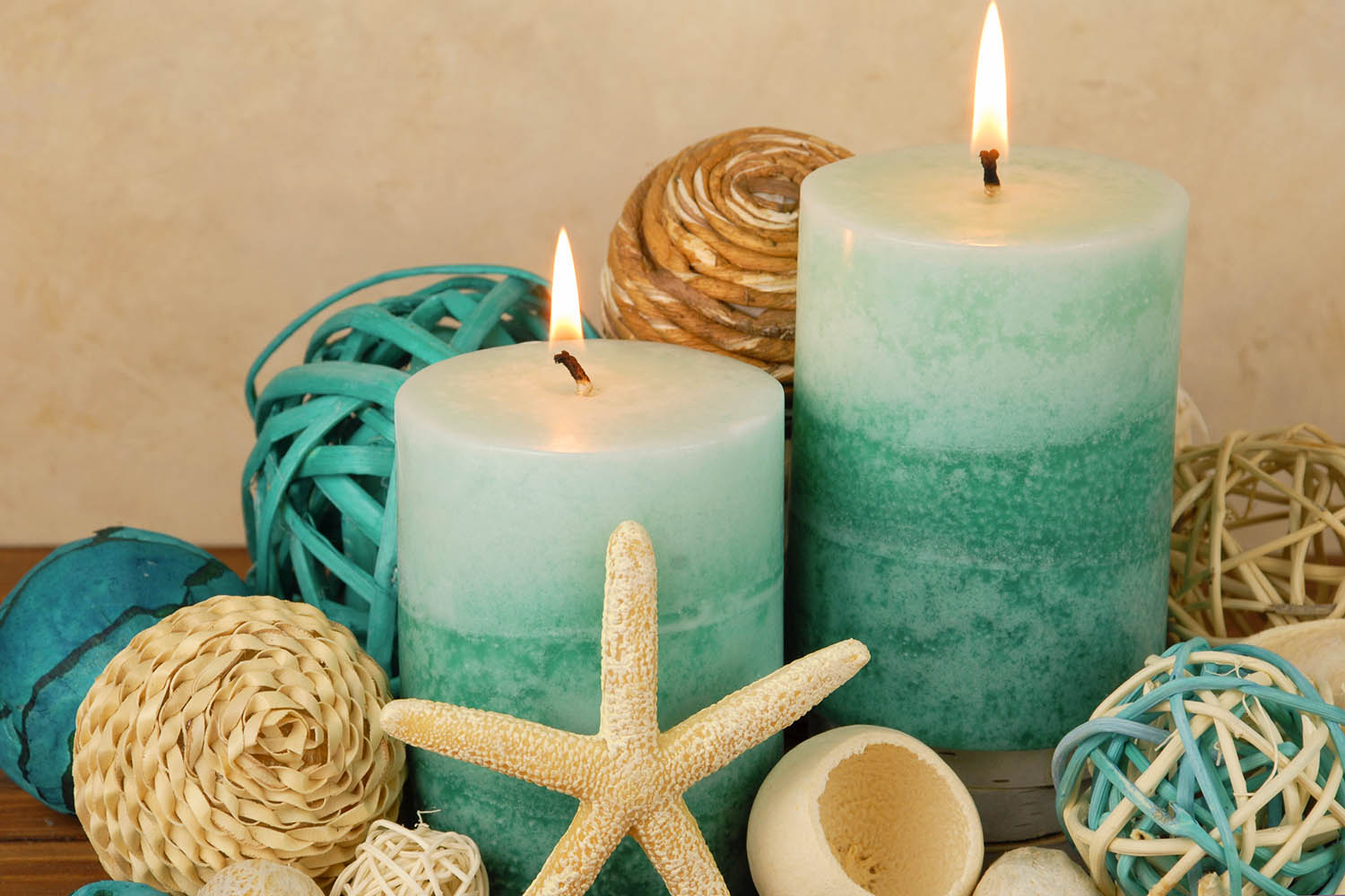 Spa concept with blue and teal colored burning candles arranged